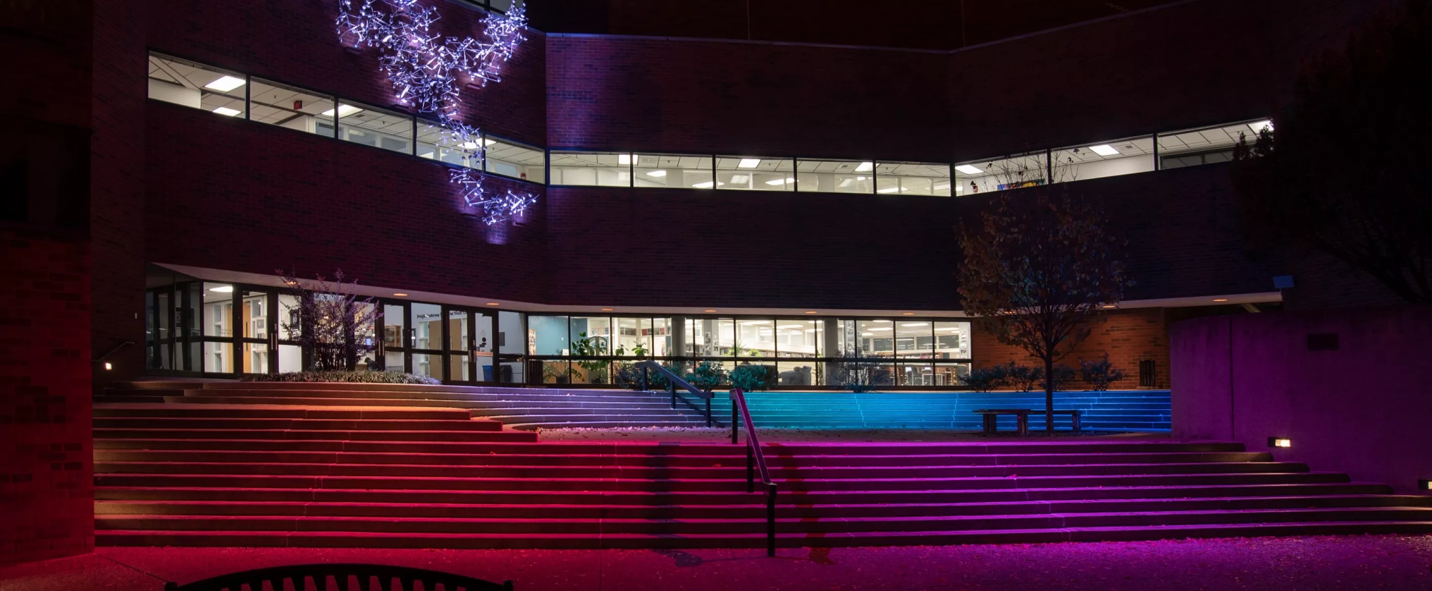Music School lit up at night with colorful lighting