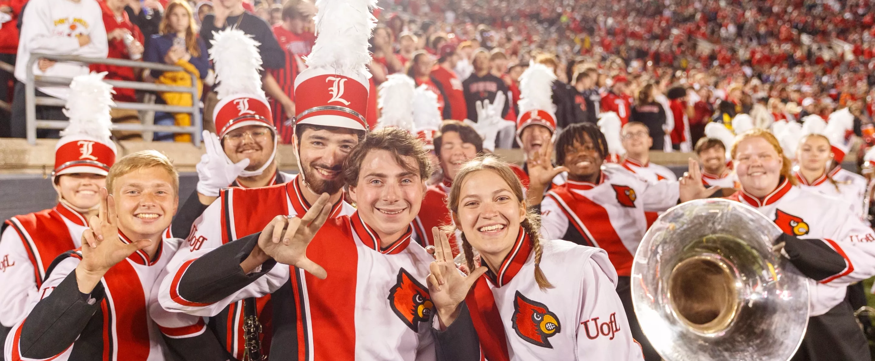 Band members throwing up their L's at the UofL vs Notre Dame football game