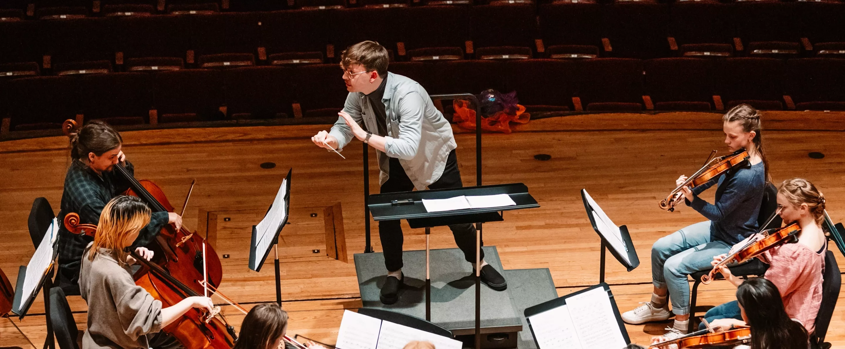 Music conductor with orchestra