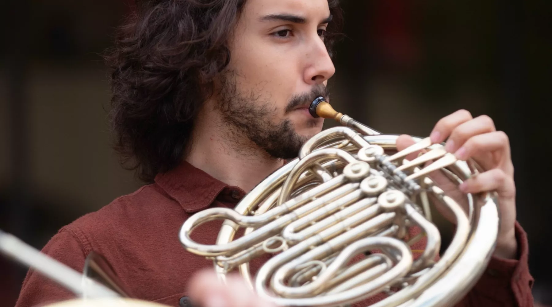 A School of Music student plays the french horn