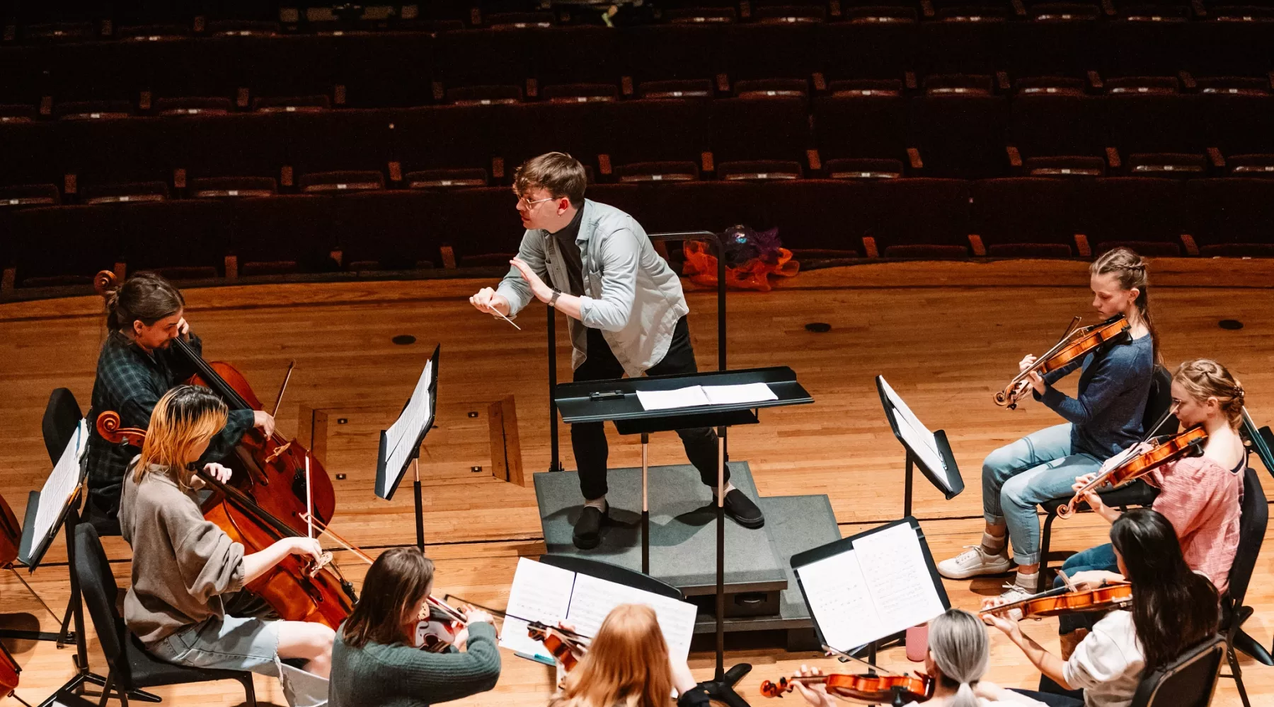 Music conductor with orchestra