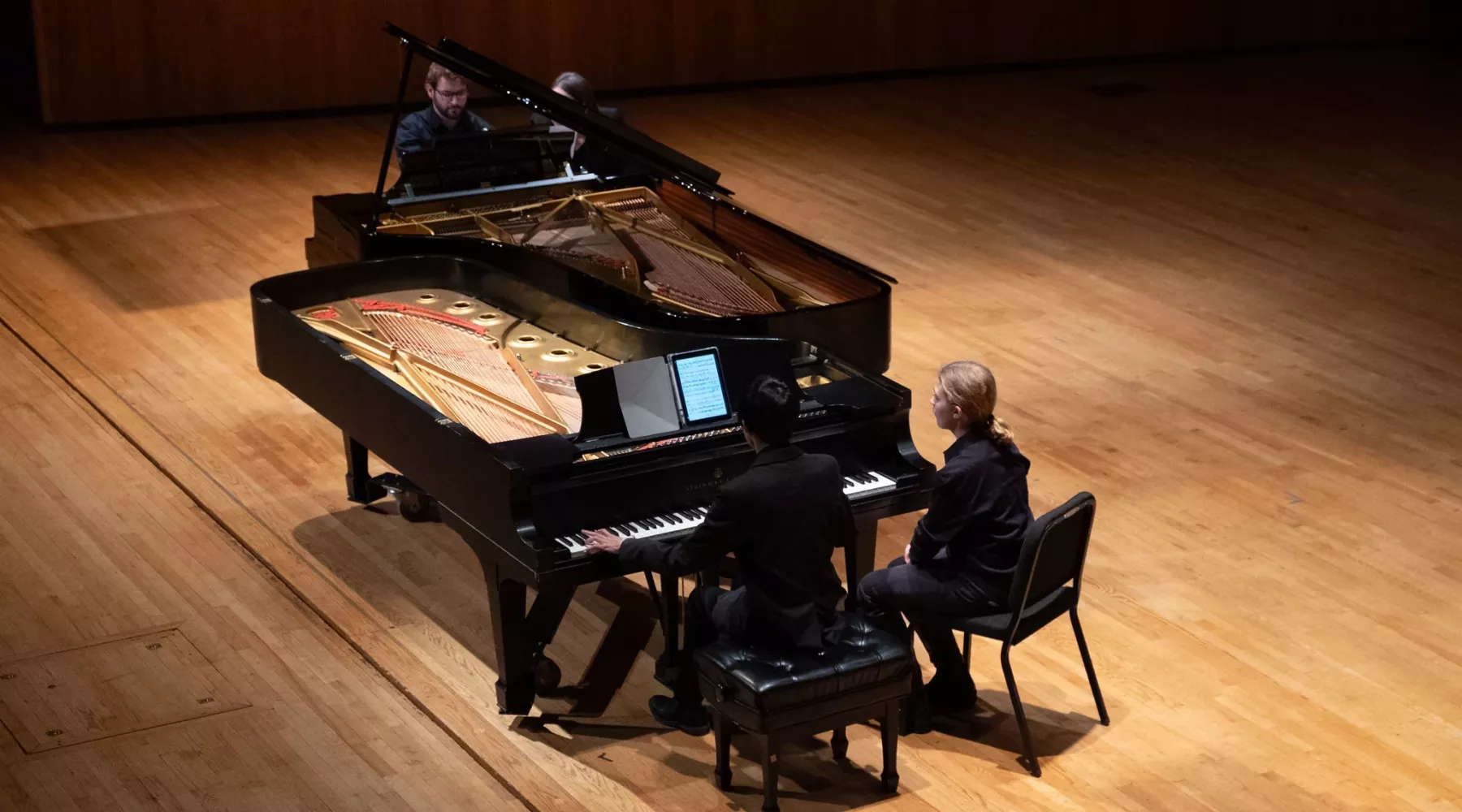 Students playing two pianos