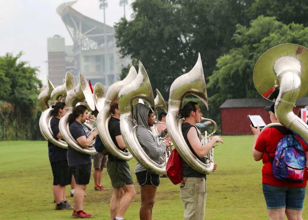 UofL Marching Cards tuba section practices on a gray day at UofL.