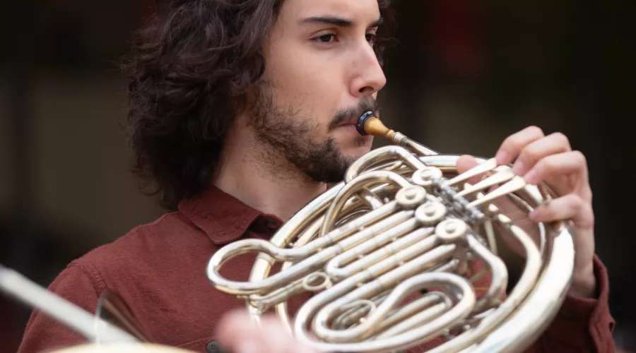 A School of Music student plays the french horn