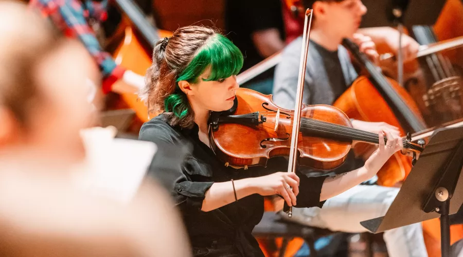 Student playing violin at Symphony Orchestra concert